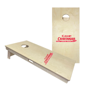Wooden cornhole boards with the Camp Chautauqua logo